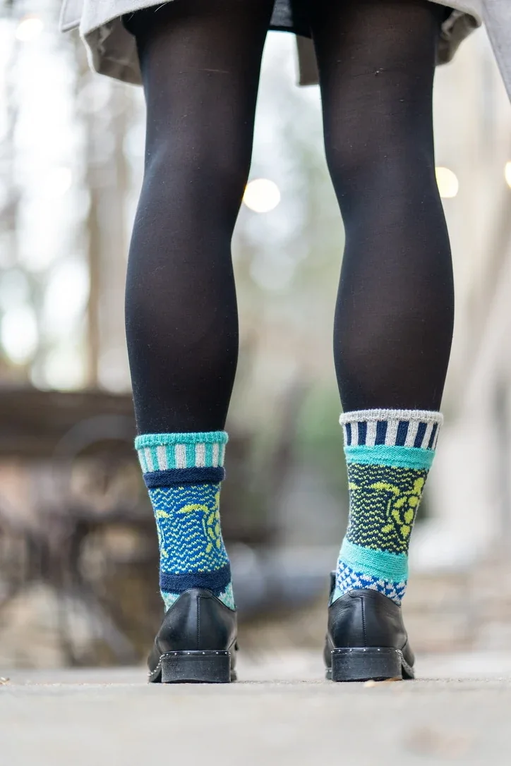 Outdoor product detail — patterned socks and black footwear.